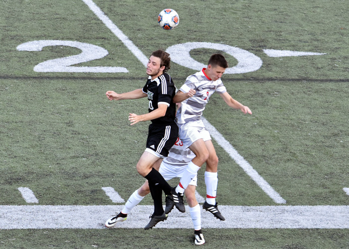 Zach den Besten (right) battles for a ball in Friday's loss to Piedmont. (Photo by Wesley Lyle)