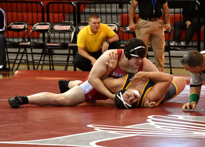 Jesse Rowlen (in red) recorded a pair of pins in the 285-pound weight class on Saturday as Huntingdon defeated the University of the Ozarks and lost to Truett-McConnell. (Photo by Wesley Lyle)